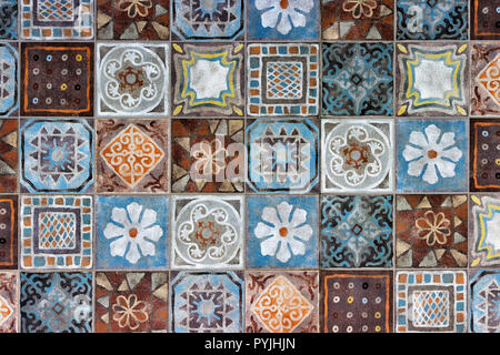 Full frame view of a decorative ceramic patchwork tile pattern with blue, brown and white rustic ornamental motifs Stock Photo