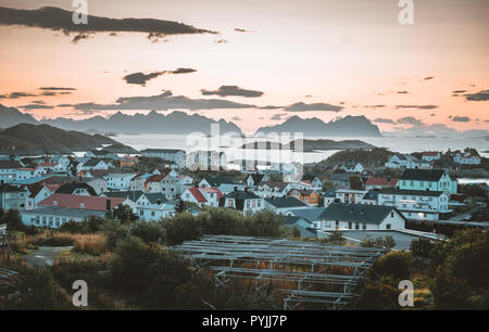 Sunrise and Sunset at Henningsvaer, fishing village located on several small islands in the Lofoten archipelago, Norway over a blue sky with clouds. P Stock Photo