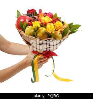 Unique festive bouquet consisting of apples, pears, mountain ash, lemons, viburnum, pomegranates and blooming roses in the hands of a girl on a white Stock Photo