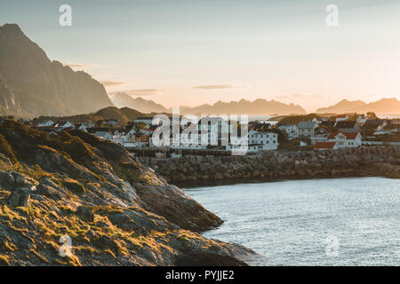 Sunrise and Sunset at Henningsvaer, fishing village located on several small islands in the Lofoten archipelago, Norway over a blue sky with clouds. P Stock Photo