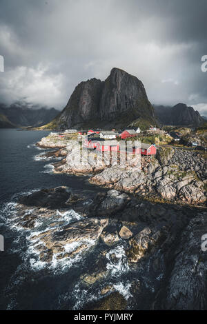 Panorama of famous tourist attraction Hamnoy fishing village on Lofoten Islands near Reine, Norway with red rorbu houses in autumn with clouds and blu Stock Photo