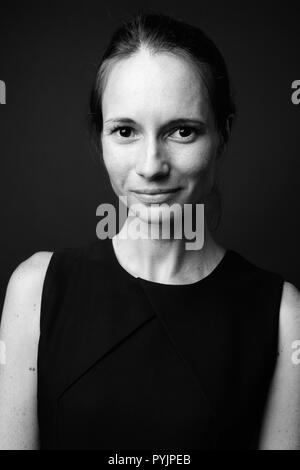 Beautiful woman wearing black sleeveless dress in black and whit Stock Photo