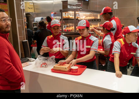 New York, USA. 28th Oct, 2018. Workers hurry to prepare orders in the Jollibee fast food restaurant in Midtown Manhattan in New York on opening day Saturday, October 27, 2018 . The restaurant chain, which has been dubbed the Philippine McDonald's because of its ubiquity and popularity in the country, opened its first location to Manhattan in the Times Square area. Jollibee Foods Corp., which has plans to open hundreds of stores in the U.S. and Canada also holds a stake in the Smashburger chain. (© Richard B. Levine) Credit: Richard Levine/Alamy Live News Stock Photo