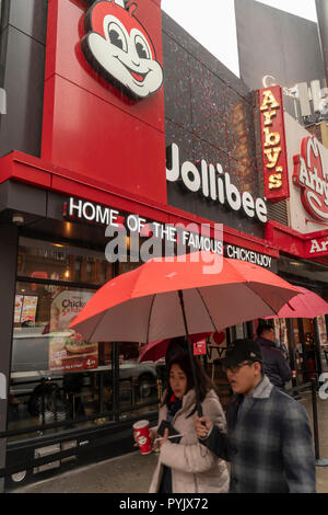 New York, USA. 28th Oct, 2018. The Jollibee fast food restaurant in Midtown Manhattan in New York on opening day Saturday, October 27, 2018 . The restaurant chain, which has been dubbed the Philippine McDonald's because of its ubiquity and popularity in the country, opened its first location to Manhattan in the Times Square area. Jollibee Foods Corp., which has plans to open hundreds of stores in the U.S. and Canada also holds a stake in the Smashburger chain. (Â© Richard B. Levine) Credit: Richard Levine/Alamy Live News Stock Photo