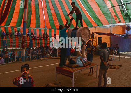 Manikganj, Manikganj, Bangladesh. 26th Dec, 2017. Child seen on top of a drum with other performers performing during a show.Circus used to be one of the great and affordable source of entertainment, which has almost been lost in time. In Bangladesh, some small circus troops are still doing their operations and trying to keep up the tradition of circus. Credit: Ziaul Haque Oisharjh/SOPA Images/ZUMA Wire/Alamy Live News Stock Photo