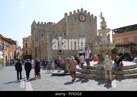 Taormina, Italy. 03rd Sep, 2018. Tourists strolling along the square in front of the San Nicolo Cathedral, called the Cathedral of the Fortress, and the baroque Centaur Fountain. The cathedral was built in the 15th century on the ruins of a smaller church from the early Middle Ages. The building consists of a main nave and two side naves, each with three small altars. Credit: Alexandra Schuler/dpa/Alamy Live News Stock Photo