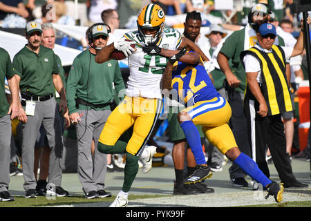 Los Angeles, California, USA. 28th Oct, 2018. CA.Green Bay Packers wide receiver Equanimeous St. Brown #19 catches the pass and is tackled by Los Angeles Rams cornerback Marcus Peters #22 in action during the third quarter of the NFL football game against the Green Bay Packers at the Los Angeles Memorial Coliseum in Los Angeles, California.Mandatory Photo Credit: Louis Lopez/CSM/Alamy Live News Stock Photo