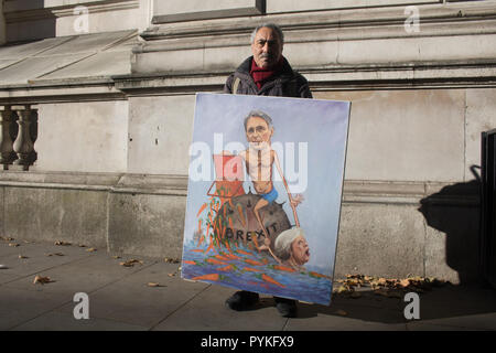London, UK. 29th Oct, 2018. Political satirist Kaya Mar stands outside Downing Street with a painting of Chancellor of the Exchequer Philip Hammond befiore he delivers the Autumn budget and the last before Brexit Credit: amer ghazzal/Alamy Live News Stock Photo
