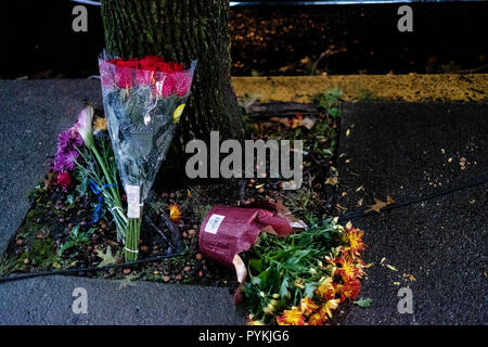 Flowers seen on the floor in memory for the victims of the shooting. After the tragic shooting in Pittsburgh, PA at the Tree of Life. Community gathers from all different races and religions.  Many have driven and flown many hours to get there to show support. Stock Photo