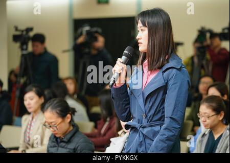 Beijing, China. 29th Oct, 2018. A journalist raises questions related to the first China International Import Expo (CIIE) at a press conference held by the Ministry of Commerce in Beijing, capital of China, on Oct. 29, 2018. Chinese President Xi Jinping will attend the opening ceremony of the first CIIE in Shanghai on Nov. 5, a senior official said Monday. Xi will deliver a keynote speech at the ceremony and visit the country pavilions with foreign leaders, Vice Commerce Minister Fu Ziying told a press conference. Credit: Xing Guangli/Xinhua/Alamy Live News Stock Photo