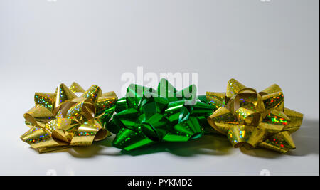 Stylish christmas gift wrapped in gold paper and green ribbon, festive  decorations on green Stock Photo by Sonyachny