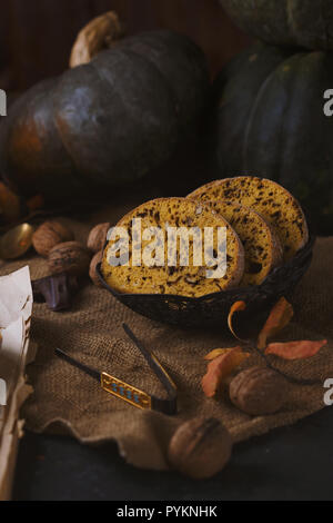 Biscotti cake with nuts, chocolate and pumpkin on a dark table Autumn concept Stock Photo