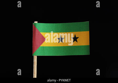 A official flag of Sao Tomé and Príncipe on toothpick on black background. Sao Tomé and Príncipe is located in central africa on island Stock Photo