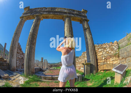 Travel photographer with reflex at columns of Ancient Messene, Archaeological Site, Peloponnese, Greece. summer travel concept. Stock Photo