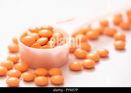 Orange pills on a counting tray Stock Photo