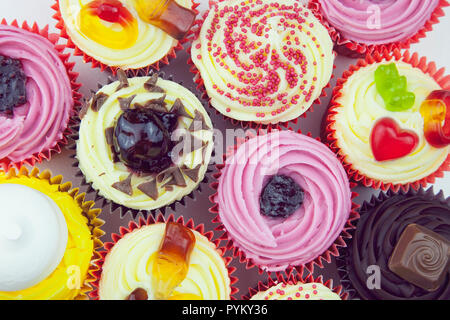 Studio shot of various colouful and decorated cup cakes. Stock Photo