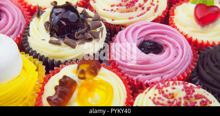 Studio shot of various colouful and decorated cup cakes. Stock Photo