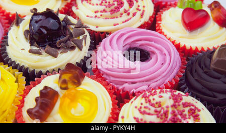 Studio shot of various colouful and decorated cup cakes. Stock Photo