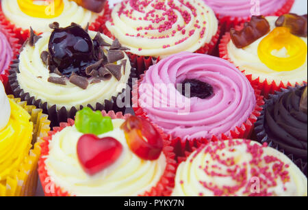 Studio shot of various colouful and decorated cup cakes. Stock Photo