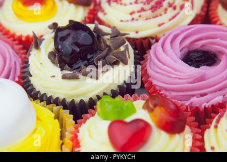 Studio shot of various colouful and decorated cup cakes. Stock Photo