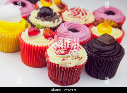 Studio shot of various colouful and decorated cup cakes. Stock Photo