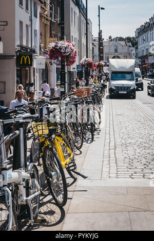 London, UK - August 1, 2018: Bicycles chained to a railing in Richmond, a suburban town in south-west London famous for a large number of parks and op Stock Photo