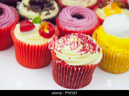 Studio shot of various colouful and decorated cup cakes. Stock Photo