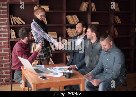 handshake of two designers at a working meeting in the office Stock Photo