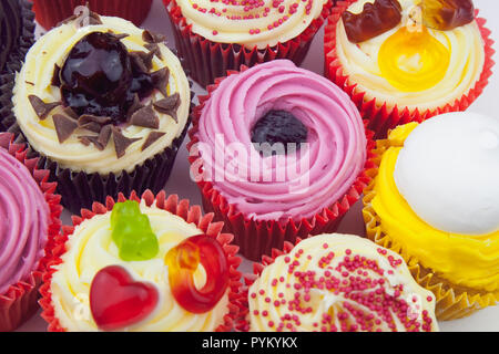 Studio shot of various colouful and decorated cup cakes. Stock Photo