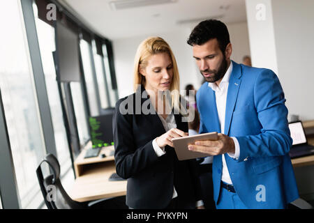 Attractive business couple using tablet in their company Stock Photo