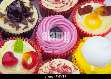 Studio shot of various colouful and decorated cup cakes. Stock Photo