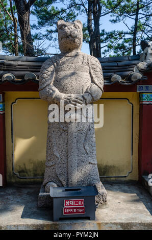 Stone sculpture representing the tiger deity from the Chinses Zodiac, seen here at Haedong Yonggung Temple, Busan, South Korea. Stock Photo