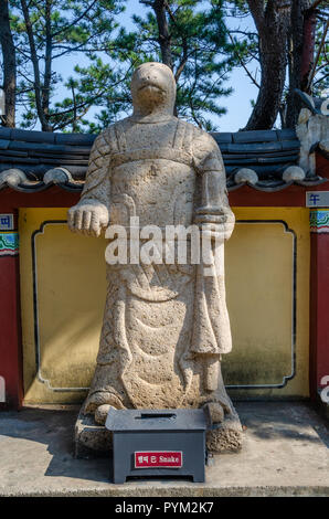 Stone sculpture representing the snake deity from the Chinses Zodiac, seen here at Haedong Yonggung Temple, Busan, South Korea. Stock Photo