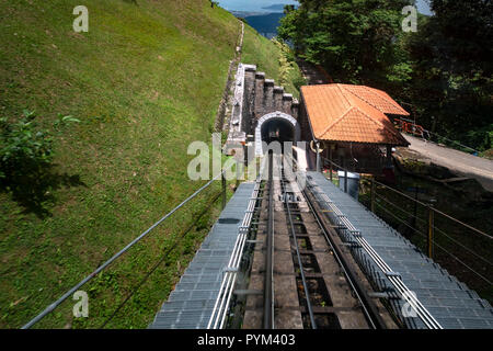 Entering into the tunnel of Penang hill , built during the British presence, on the train from the hill of the mountain with Penang city in the backgr Stock Photo