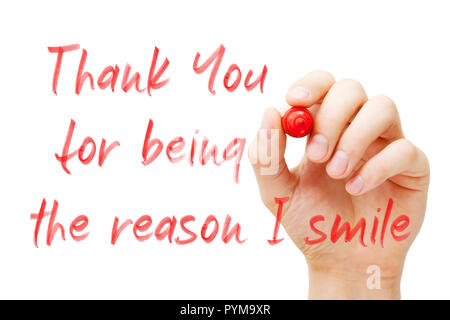 Hand writing quote Thank You For Being The Reason I Smile with red marker on transparent wipe board isolated on white. Stock Photo