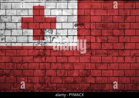 Tonga flag is painted onto an old brick wall Stock Photo