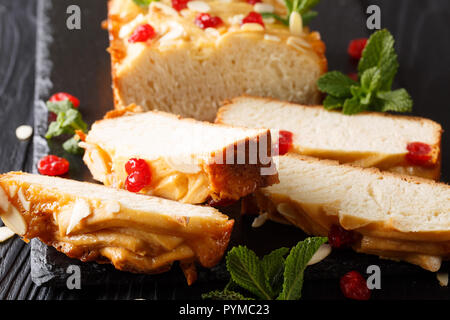 Japanese condensed milk bread decorated with dried cherries, almonds and mint close-up on the table. horizontal Stock Photo