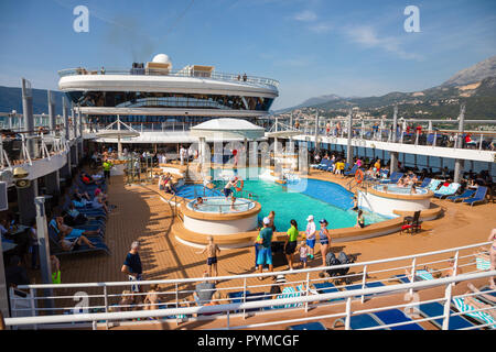 Mediterranean sea, Montenegro - 15.10.2018: Tourists relax at swimming pool at Cruise liner Norwegian Star during a cruise to Greece Stock Photo