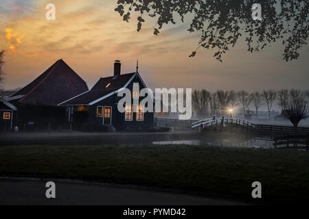 Ducks flying over a beautiful typical Dutch wooden houses architecture at the sunrise moment mirrored on the calm canal of Zaanse Schans located in th Stock Photo