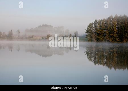 CALM LAKE SCENE IN EARLY MORNING LIGHT Stock Photo