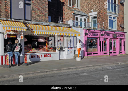 A view of tourist shops alongside the harbour in Whitby, North Yorkshire, UK. Stock Photo