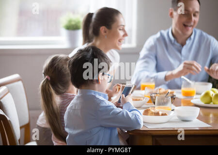 Family with children having breakfast in the kitchen Stock Photo