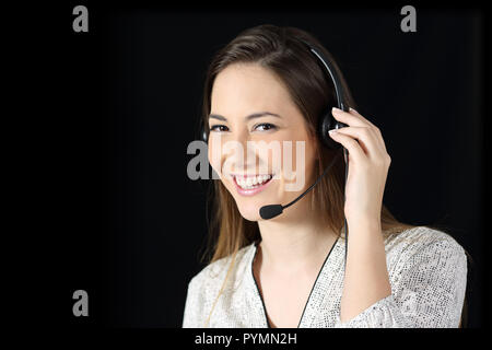 Happy tele marketer looking at camera on black background Stock Photo