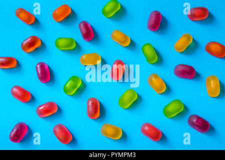 Colorful jelly candy pattern on a blue background, top view Stock Photo