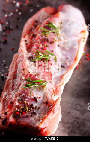 Raw ribs with spices on a stone background with empty space for text Stock Photo
