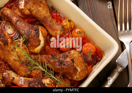 Roasted chicken legs on the ceramic bowl cooked with vegetables Stock Photo