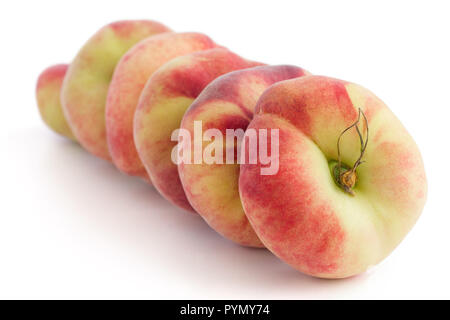 Group of ripe flat peaches on white Stock Photo