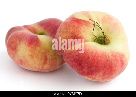 Group of ripe flat peaches on white Stock Photo