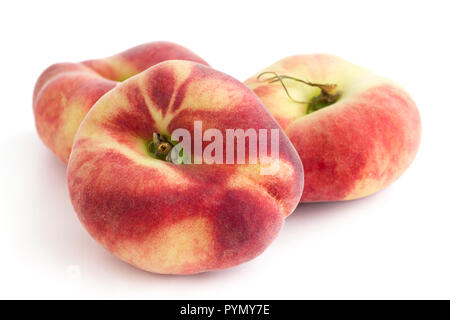 Group of ripe flat peaches on white Stock Photo