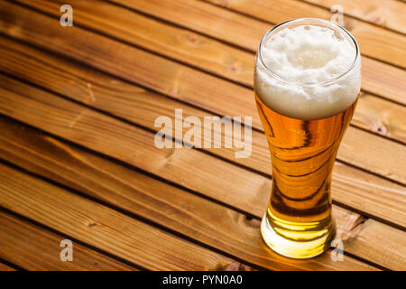 Glass of beer on wooden table. Stock Photo